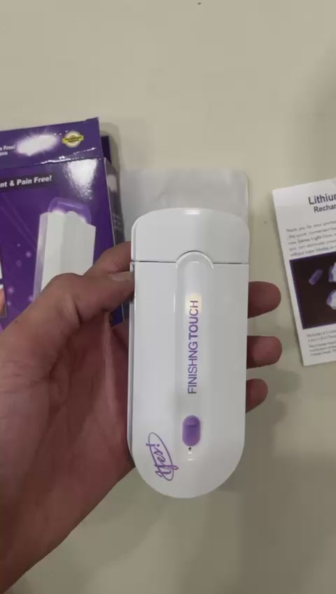 Unboxing of the Finishing Touch hair remover machine showing the device, box, head and leaflet
